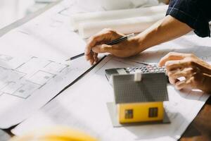 architect man working with laptop and blueprints,engineer inspection in workplace for architectural plan,sketching a construction project ,selective focus,Business concept vintage color photo