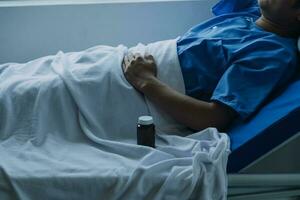 young injured man in hospital room sitting alone in pain looking negative and worried for his bad health condition sitting on chair suffering depression on a sad lonely medical background photo