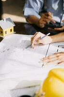 architect man working with laptop and blueprints,engineer inspection in workplace for architectural plan,sketching a construction project ,selective focus,Business concept vintage color photo