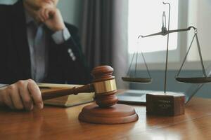 Business and lawyers discussing contract papers with brass scale on desk in office. Law, legal services, advice, justice and law concept picture with film grain effect photo