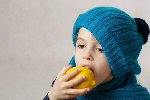 Six years old boy with yellow lemon. photo