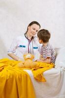 A child and a paediatrician in her cabinet photo