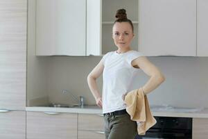 Young lady stays in front newly installed kitchen photo