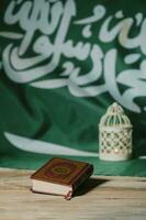 Sacred book of Quran on a wooden surface. photo