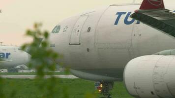 ALMATY, KAZAKHSTAN MAY 4, 2019 - Turkish Cargo Airbus A330 TC JDR braking after landing on runway at rainy weather. Airport of Almaty, Kazakhstan video