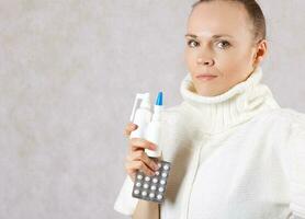 Young caucasian lady  dressed in a knitted sweater with medication. Closeup photo