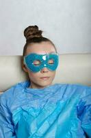 Young lady is keeping eye gel mask. photo