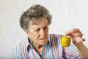 Old woman and dehydrated apple photo