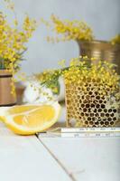 Mimosa flowers, honeycomb,two pieces of lemon photo