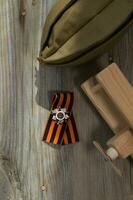 Military cap, airplane, and badge on a Saint George ribbon. photo