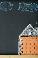 Painted house and the yard in a colourful chalk. Closeup photo