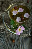 Fresh rose hip on a cup plate. photo