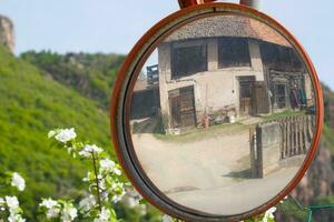 Traffic mirror in a countryside photo