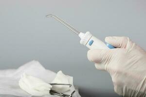 Oral irrigator on a gray background. photo