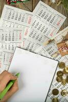 Blank sheet of paper and small purse with coins on the New Year's background. photo