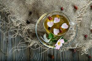 Rose hip herbal tea on a wooden surface. Free text. photo