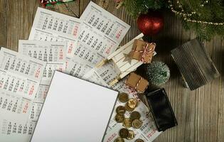 Blank sheet of paper and small purse with coins on the New Year's background. photo