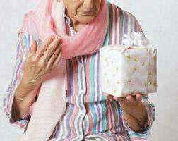 Old woman and a present photo