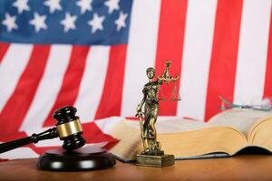 Statue of Themis and judge's gavel on a table. photo