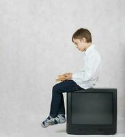 Boy and an old TV. Free space for a text. photo