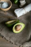 Avocado section on a wooden surface. photo