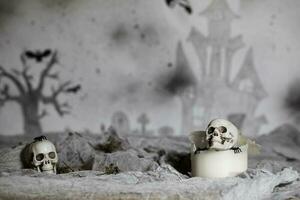 Skull on an old used thick candle. Scary Halloween background. photo