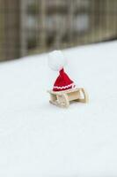 Santa Claus hat on a wooden made sleigh. photo