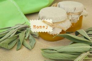 Glass  bottle of sage honey photo