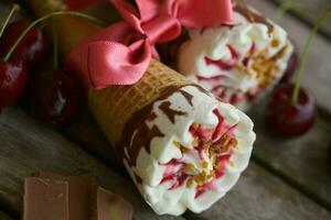 Cherry vanilla ice-cream with caramel topping. Closeup photo