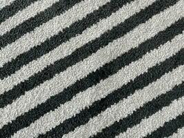 white rug or carpet stripe pattern with black stripes. texture background black and white nobody.abstract texture background. photo