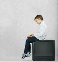 Boy and an old TV. Free space for a text. photo