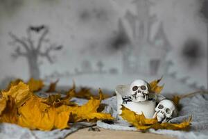 Skull on an old used thick candle. Scary Halloween background. photo