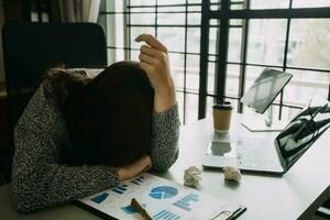 Asian women are stressed while working on laptop, Tired asian businesswoman with headache at office, feeling sick at work, copy space photo