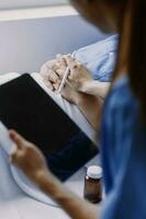 doctor check up after surgery. doctor touching patient hand and consoling. photo