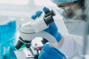 hand of scientist with test tube and flask in medical chemistry lab blue banner background photo