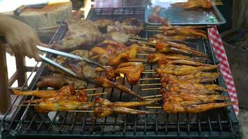 Barbecue chicken and pork on grill stove in market video