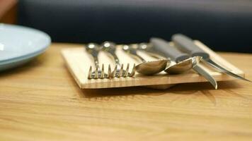 Cutlery on plate on wooden background close up video