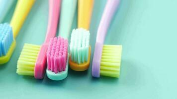 Colorful toothbrushes on a color background video