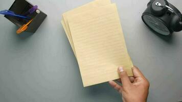 Top view of man's hand on blank paper on table video