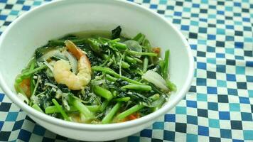 Top view of bowl with cooked spinach on table video