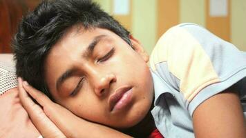 Teenage boy boy sleeping in bed, selective focus video