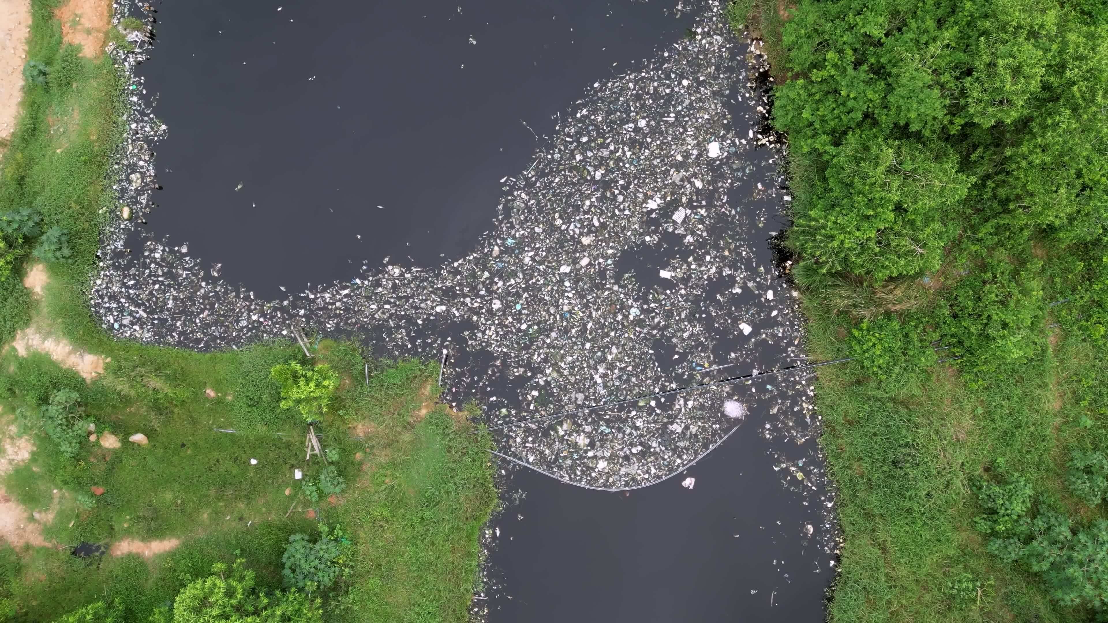 Aerial view of agricultural lands adjacent to the river in Malaysia