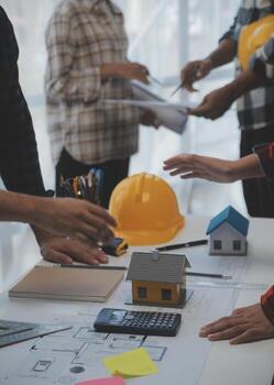 Engineer Teamwork Meeting, Drawing working on blueprint meeting for project working with partner on model building and engineering tools in working site, Construction and structure concept. photo