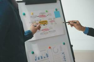 Financial analysts analyze business financial reports on a digital tablet planning investment project during a discussion at a meeting of corporate showing the results of their successful teamwork. photo