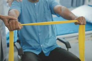 Physiotherapist man giving exercise with dumbbell treatment About Arm and Shoulder of athlete male patient Physical therapy concept photo