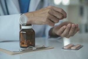 Doctor and patient discussing current health examination while sitting at the desk in clinic office, closeup. Medicine concept. photo