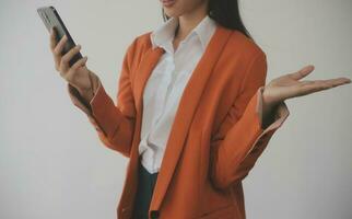 Asian Business woman using calculator and laptop for doing math finance on an office desk, tax, report, accounting, statistics, and analytical research concept photo