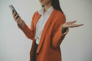 Asian Business woman using calculator and laptop for doing math finance on an office desk, tax, report, accounting, statistics, and analytical research concept photo