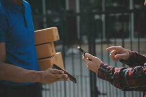 Startup small business entrepreneur of freelance Asian woman using a laptop with box Cheerful success Asian woman her hand lifts up online marketing packaging box and delivery SME idea concept photo