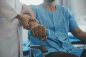 Physical therapist guiding patient with resistance band photo